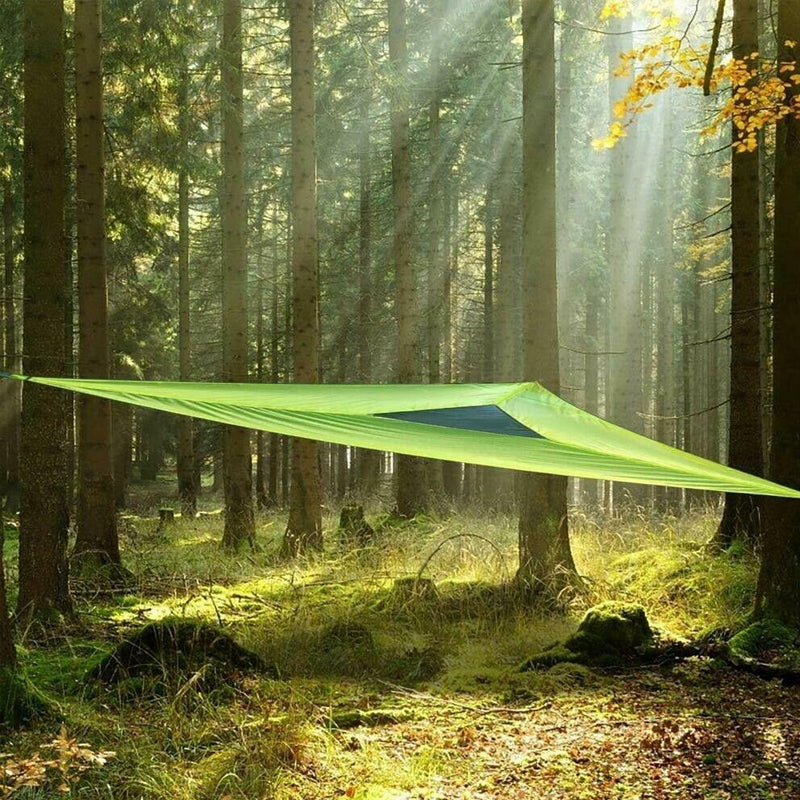 Green aerial hammock suspended in forest