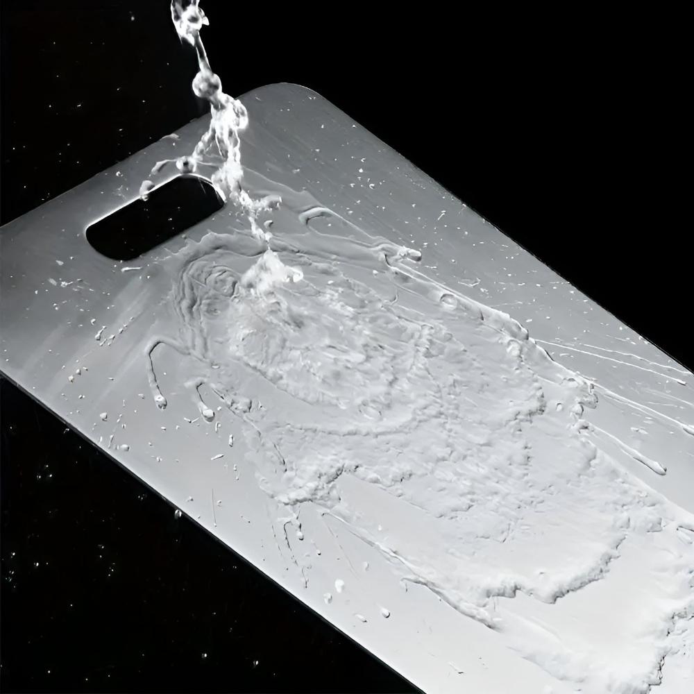Water rinsing easily off the stainless steel cutting board