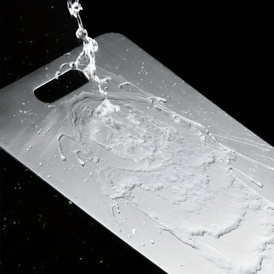 Water rinsing easily off the stainless steel cutting board
