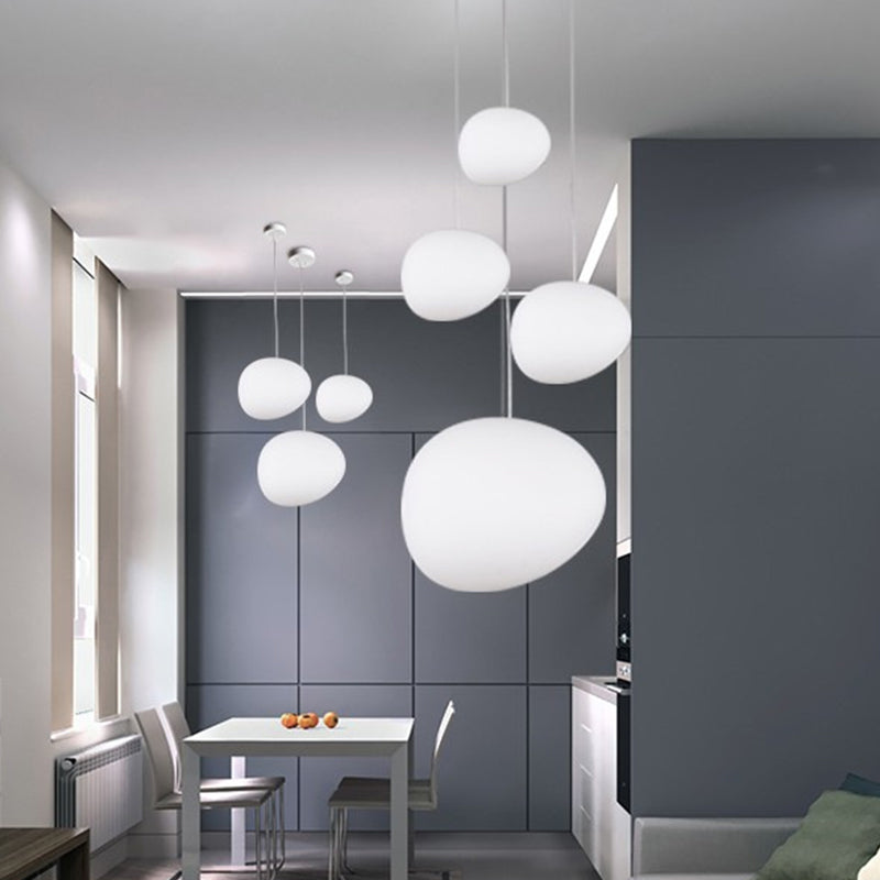 Pebble pendant lamps over dining table
