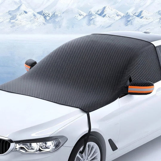 Magnetic windshield snow cover on a car in a snowy landscape