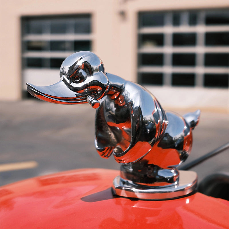Silver angry duck hood ornament on car hood