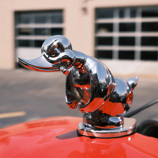 Silver angry duck hood ornament on car hood