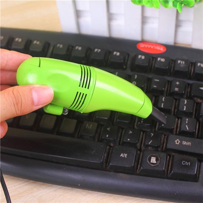 Mini vacuum cleaning a computer keyboard