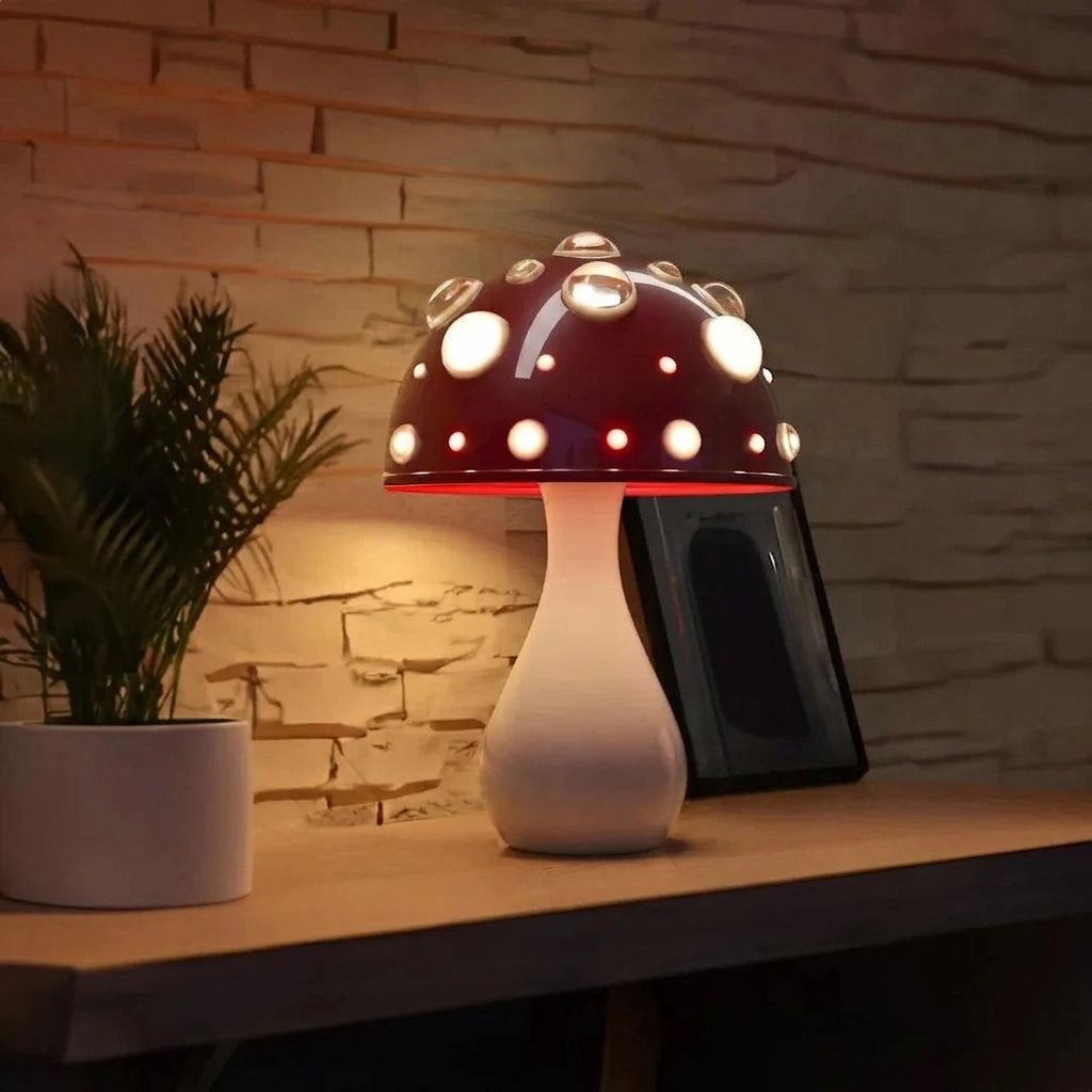 Red mushroom lamp glowing on a wood table