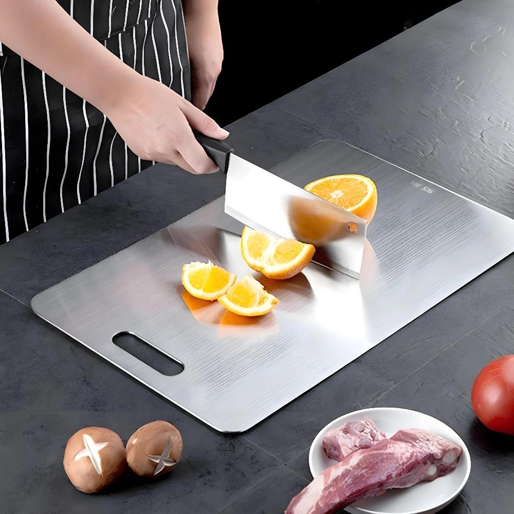 Stainless steel cutting board used to slice oranges