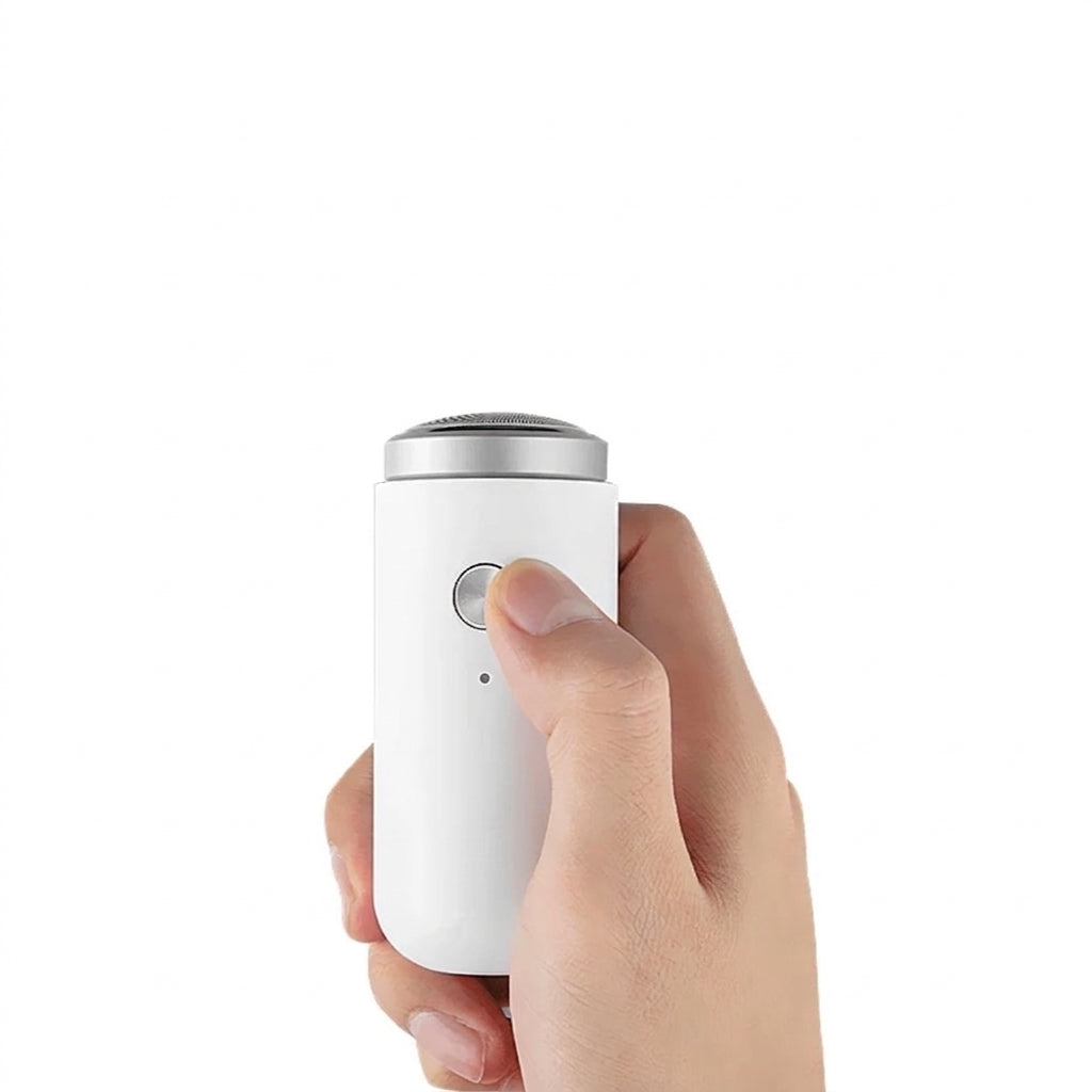 Mini electric shaver held in hand