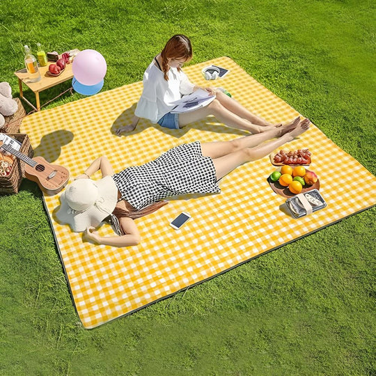Picnic blanket spread on grass