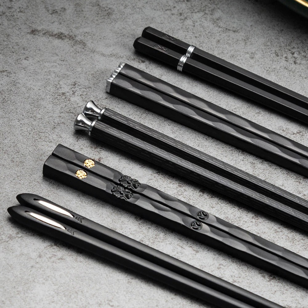 Black alloy chopsticks set on white plate