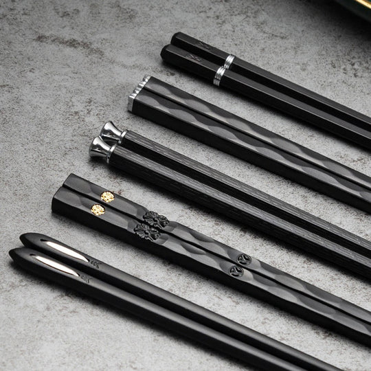 Black alloy chopsticks set on white plate