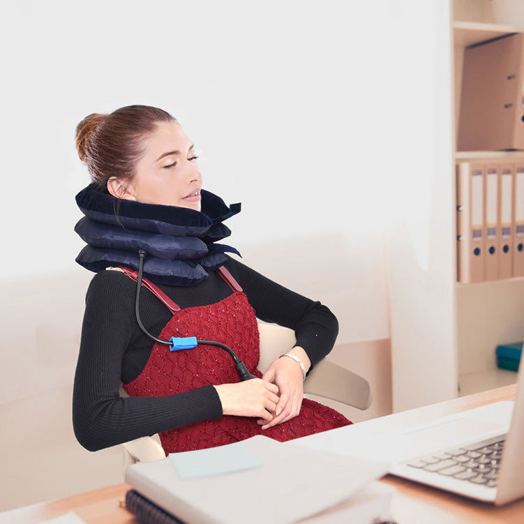 Woman using blue neck stretcher at a desk