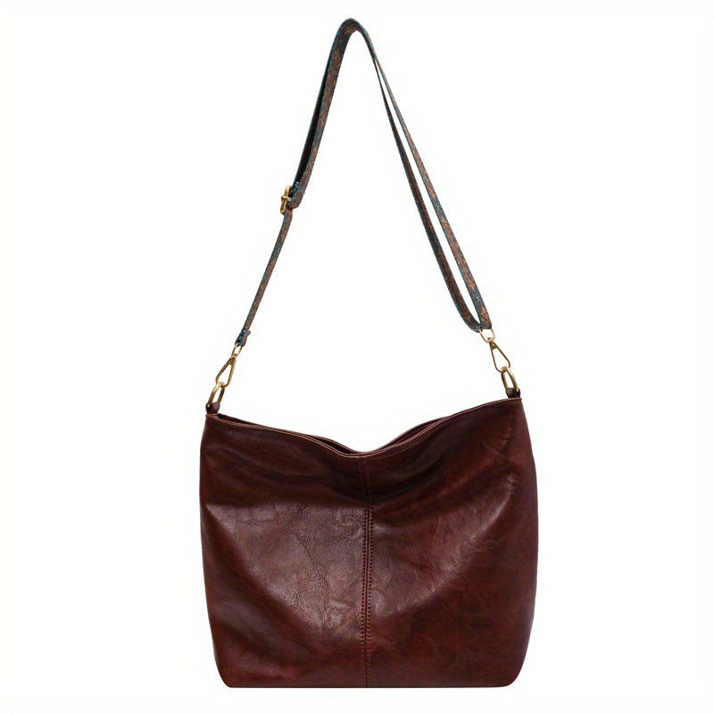 Dark brown leather shoulder bag with patterned strap