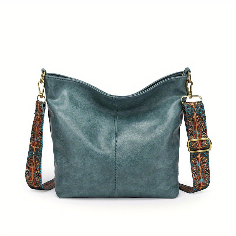 Teal leather shoulder bag with patterned strap