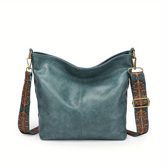 Teal leather shoulder bag with patterned strap