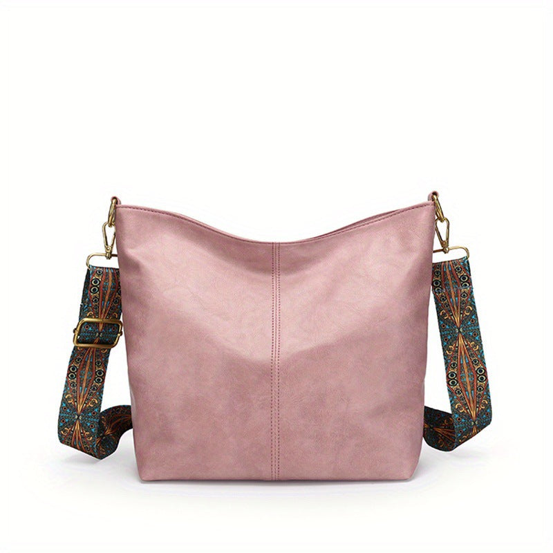 Pink leather shoulder bag with patterned strap