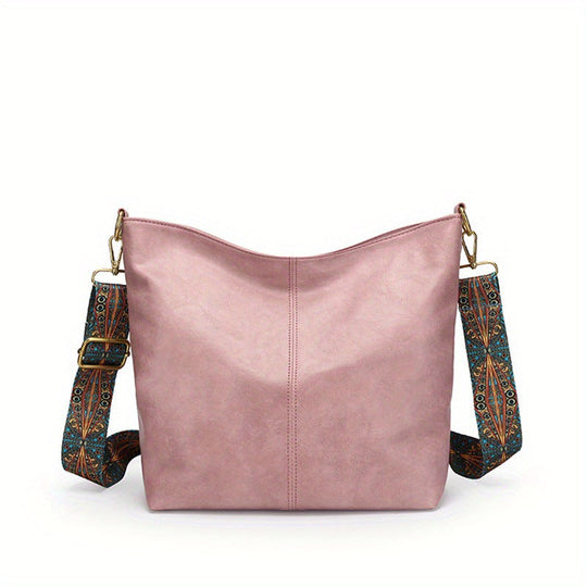 Pink leather shoulder bag with patterned strap