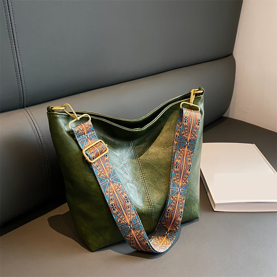 Green leather shoulder bag with patterned strap