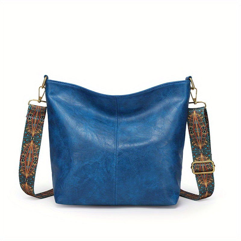 Blue leather shoulder bag with patterned strap