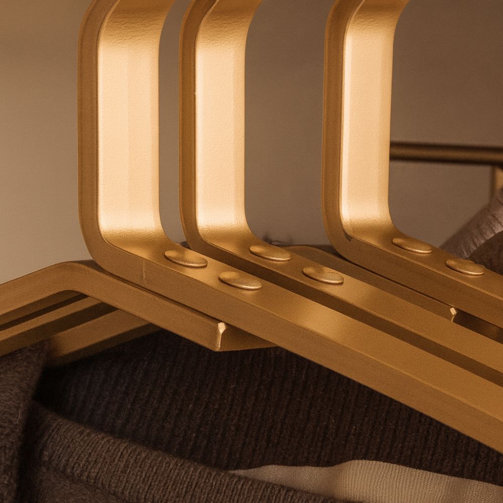 Gold alloy hangers in wardrobe