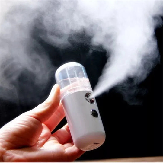 Hand holding misting facial sprayer