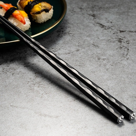 Black chopsticks with sushi