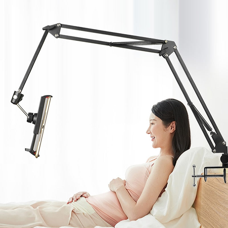 Person using tablet on long arm mount in bed