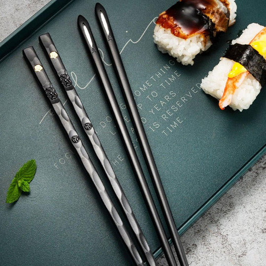 Black chopsticks on tray