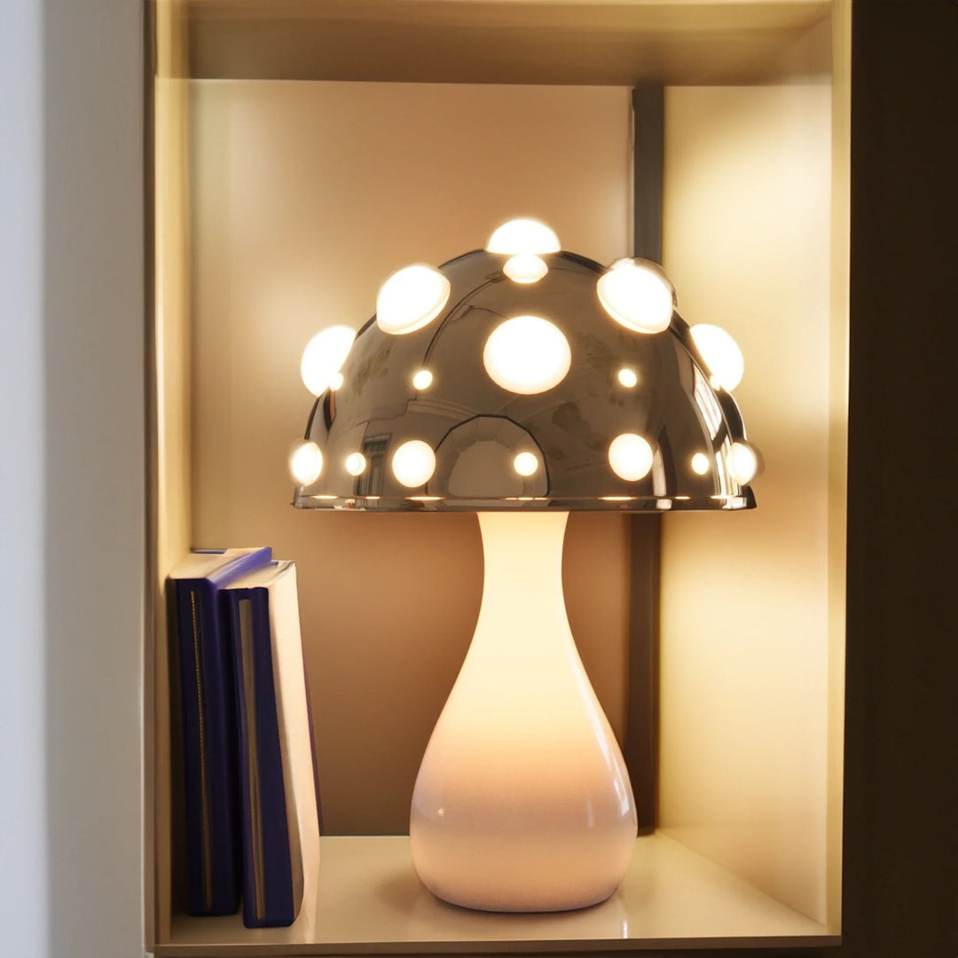 Gold mushroom lamp on a shelf with books