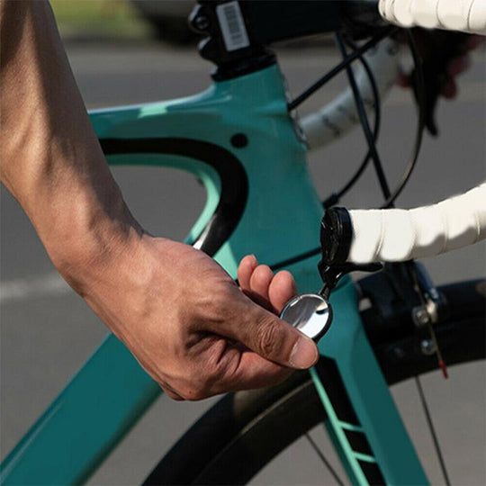 Cyclist adjusting handlebar mirror