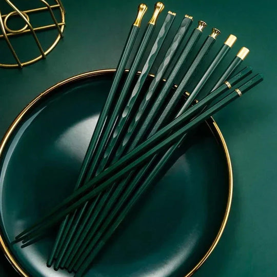Green chopsticks set on plate