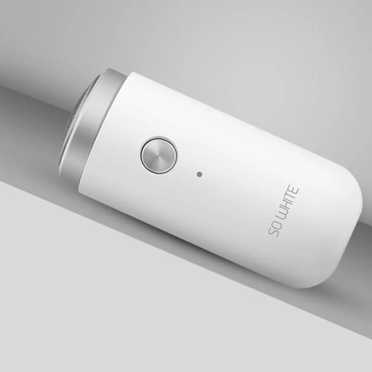 Compact white electric shaver