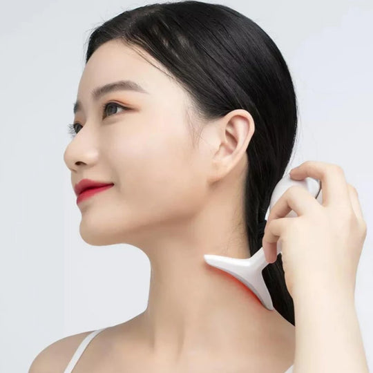 Woman using massager along the neck