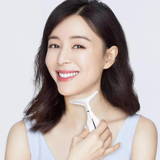 Woman holding neck and face massager