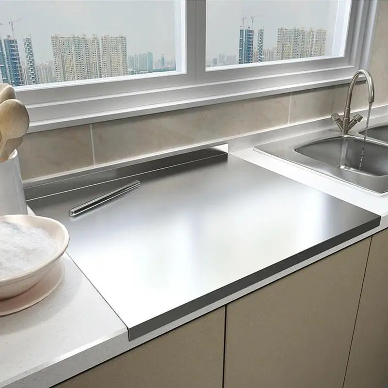 Stainless steel cutting board installed over a kitchen counter