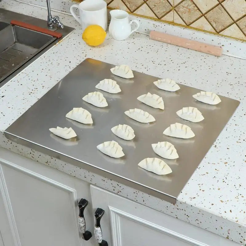 Pastry dough resting on the stainless steel board