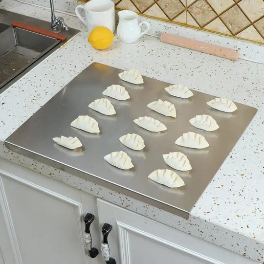 Pastry dough resting on the stainless steel board