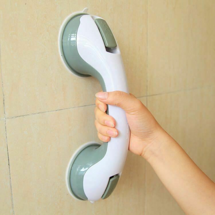 Suction-mounted bathroom safety grab bar held in hand
