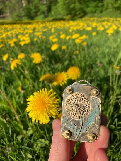 Brass and silver flower press in a garden