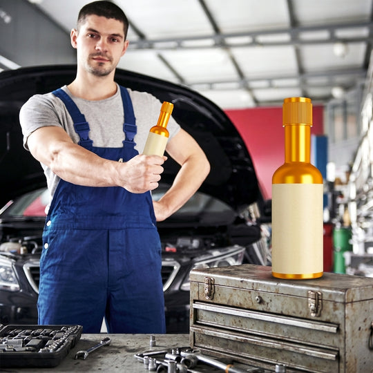 Mechanic holding engine cleaner bottle in garage