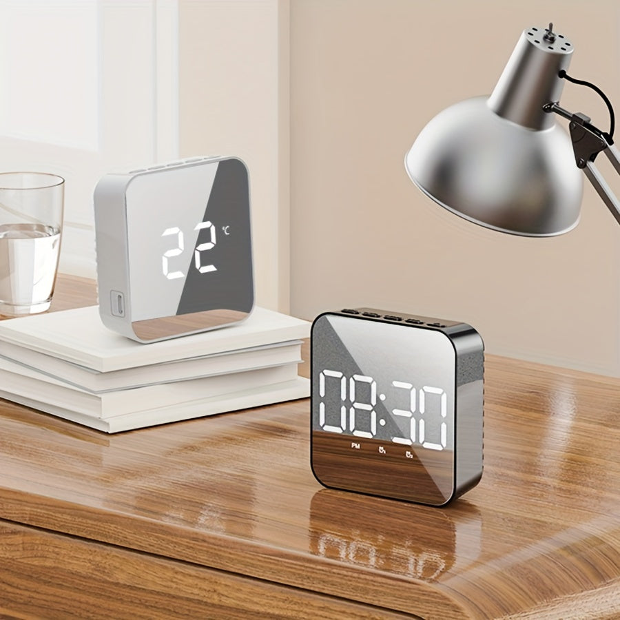 Black LED mirror alarm clock on desk
