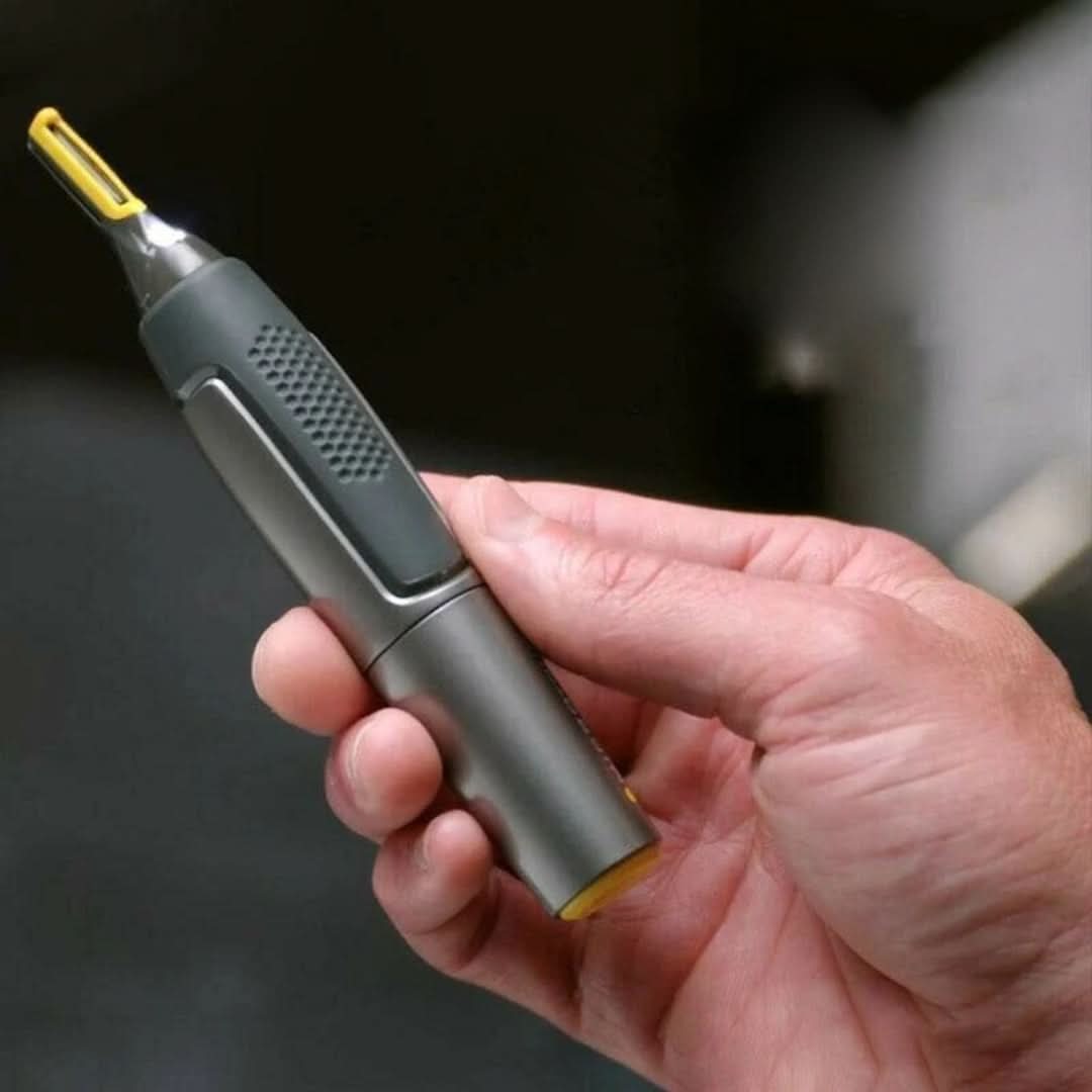 Trimmer held in hand with LED light on