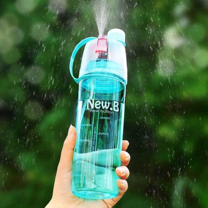 Blue mist spray water bottle held outdoors