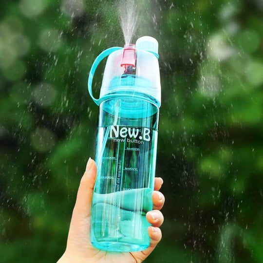 Blue mist spray water bottle held outdoors