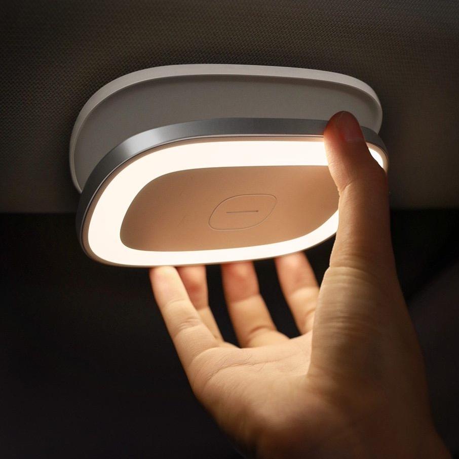 White clip-on LED reading light glowing in car
