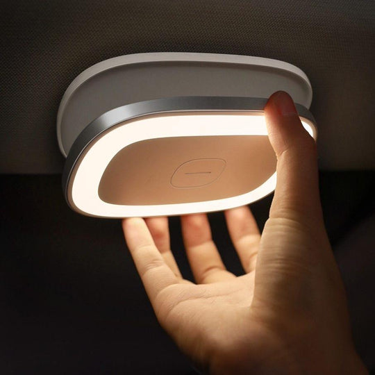 White clip-on LED reading light glowing in car