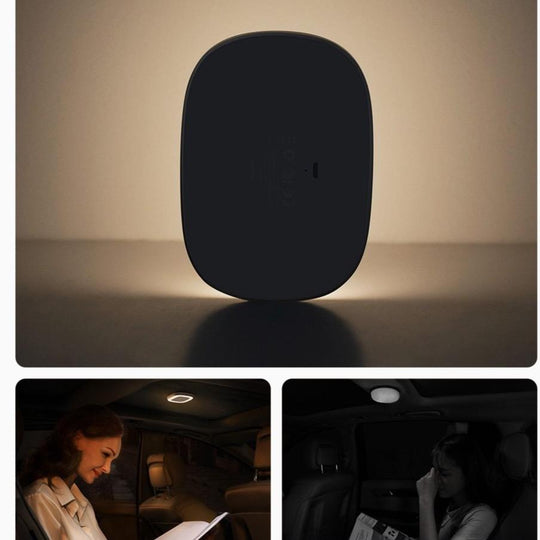 Black clip-on car reading light in use
